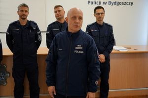 policjant gratuluje zwycięzcom i podaje nagrody